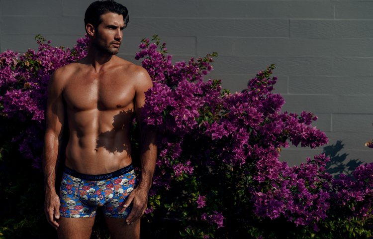 Lifestyle editorial image featuring male model Mitchell Wick wearing Cocksox CX12DD Day of the Dead Collection men's underwear boxers in Calavera Blue print